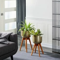 Litton Lane 24 in. x 13 in. Gold Metal Modern Planter (Set of 2) 23 Litton Lane 24 in. x 13 in. Gold Metal Modern Planter (Set of 2) -Litton Lane Sales Store gold litton lane plant pots 37886 31 1000